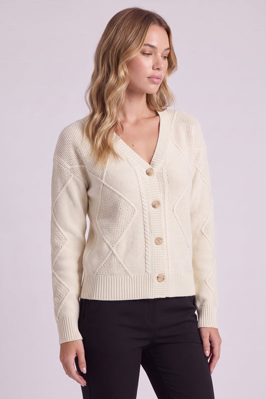 Maren Cable Knit Button Cardigan in Cream - three-quarter view