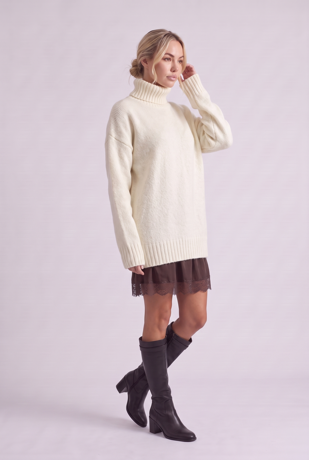 Brielle Oversized Turtleneck Sweater in White, three-quarter view