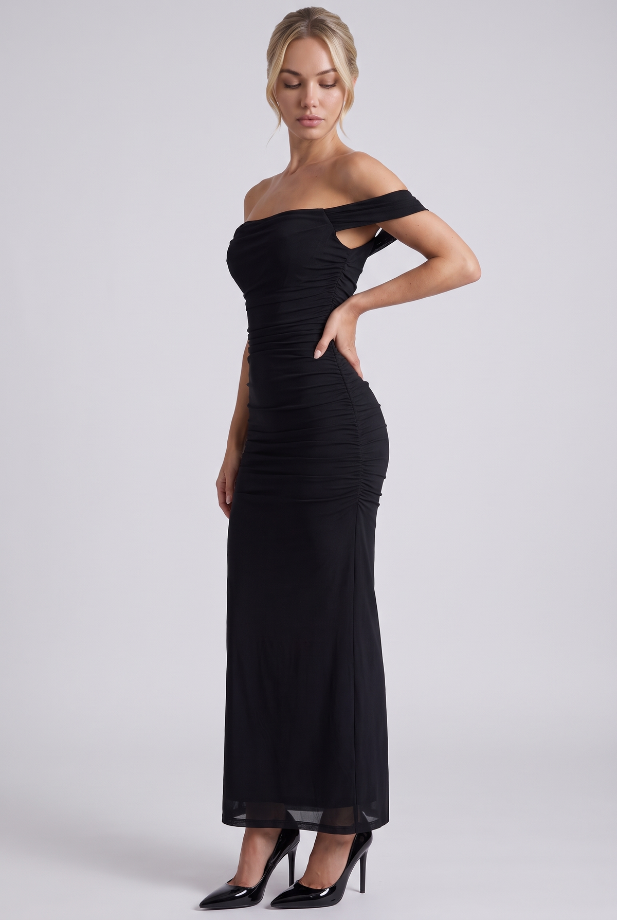 Lucienne Off-Shoulder Ruched Maxi Dress in Black - three-quarter view